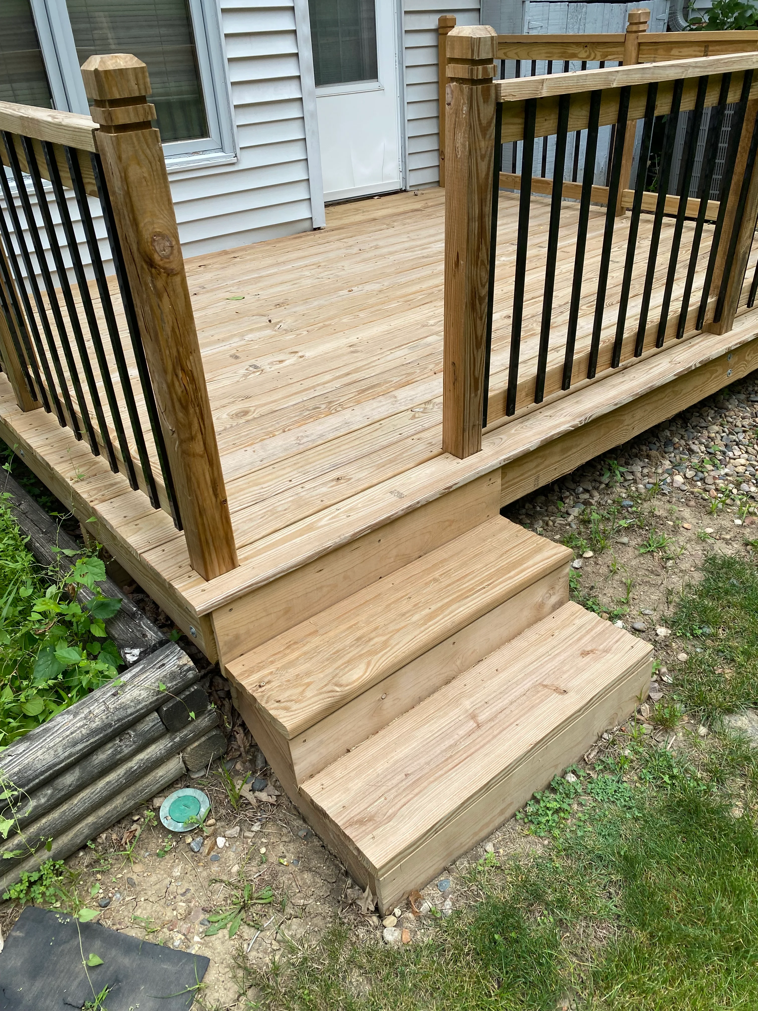 Close view of finished wood deck steps and railing
