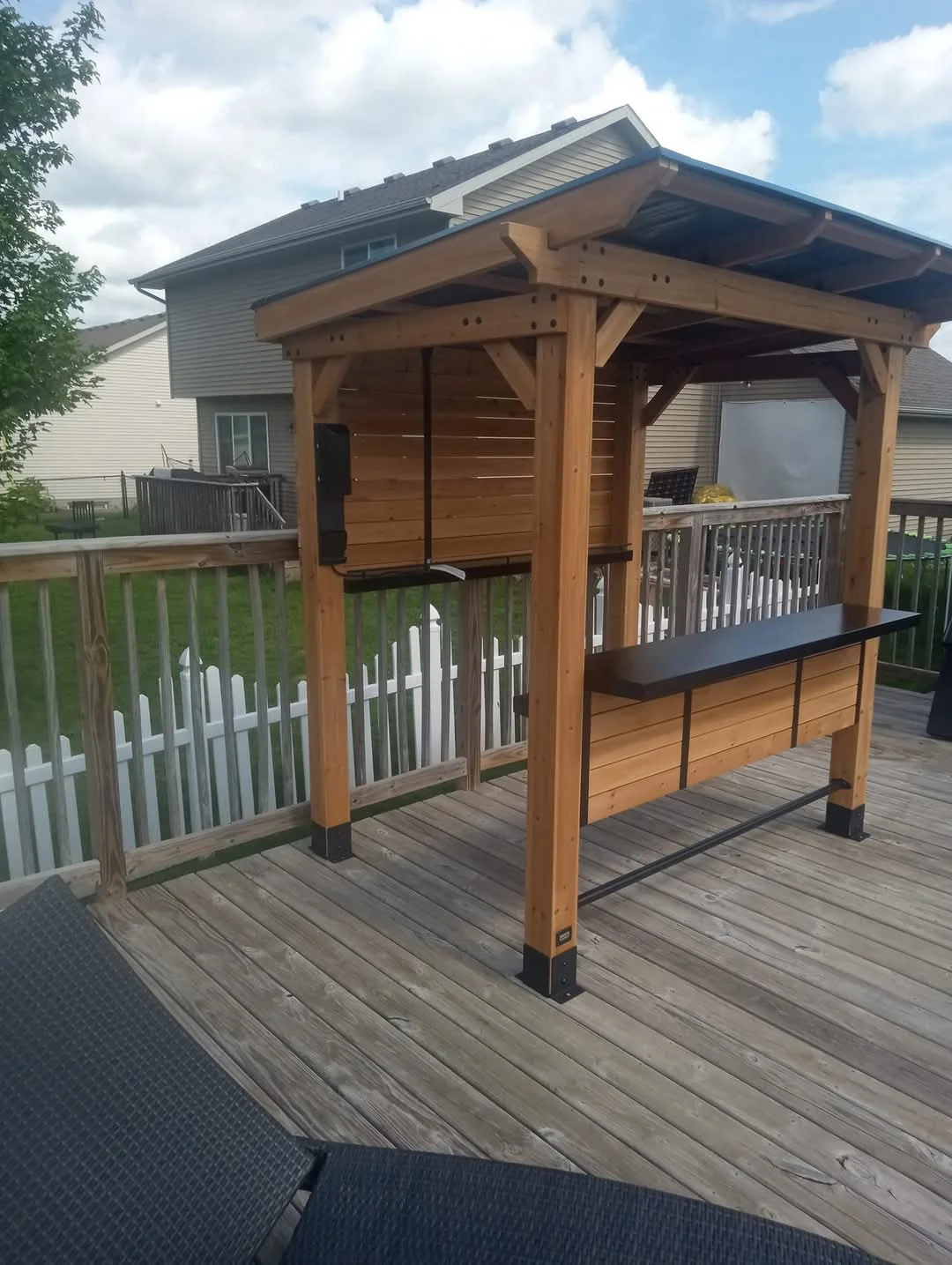 Custom wood outdoor bar built on an existing deck